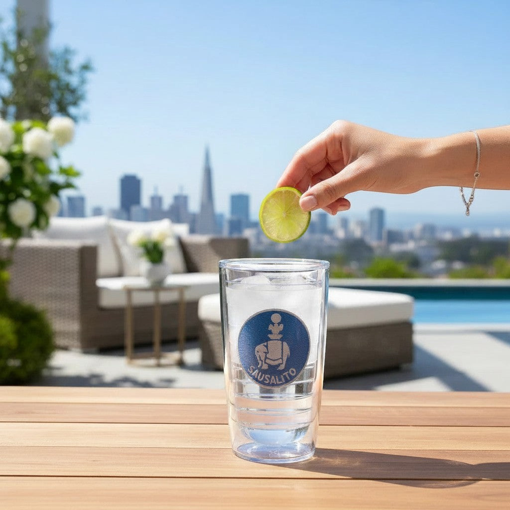 Lowkey Local 16oz Tervis tumbler featuring a Sausalito elephant logo, held on a patio with a lime slice.