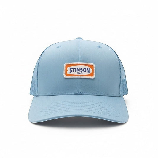 Stinson beach trucker hat in carolina blue with orange and white surfboard patch