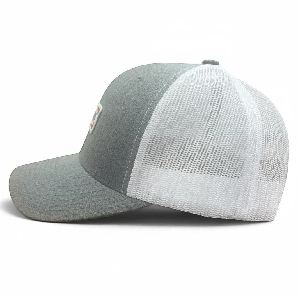 Lowkey Local Stinson Beach trucker hat with a grey front panel, white mesh back, and embroidered patch side profile.