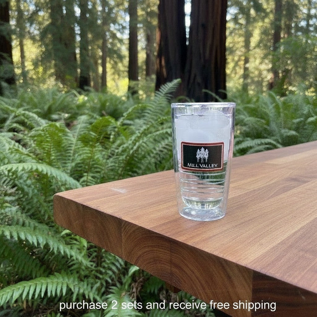 Lowkey Local Mill Valley Tervis tumbler filled with ice, sitting on a wooden table in a redwood forest setting.