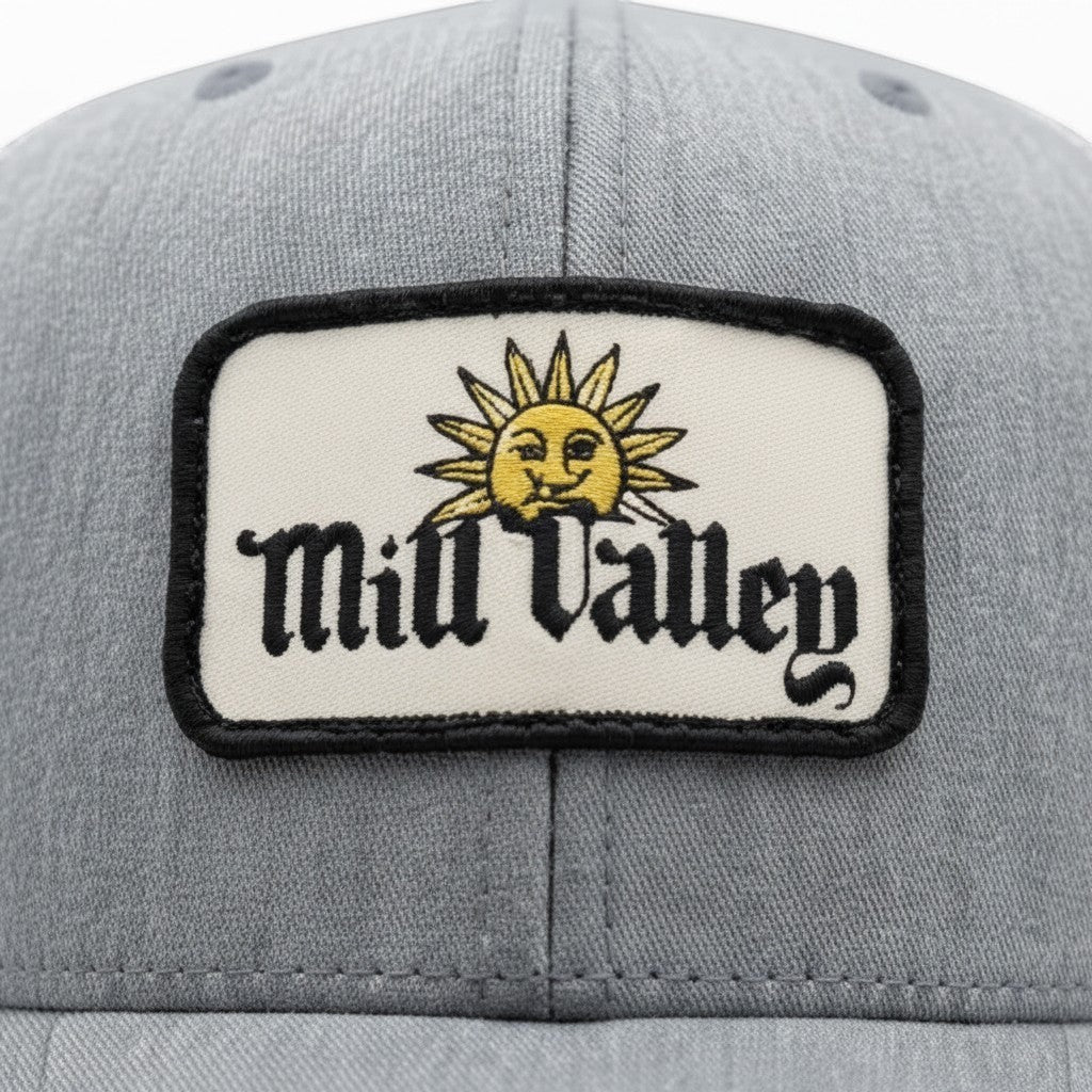 Lowkey Local Mill Valley trucker hat in heather gray with a sun patch logo on the front panel