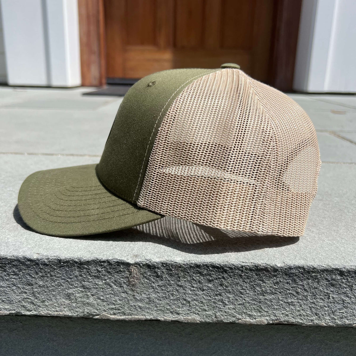 Lowkey Local moss green and tan mesh trucker hat with a structured 6-panel design and snapback closure
