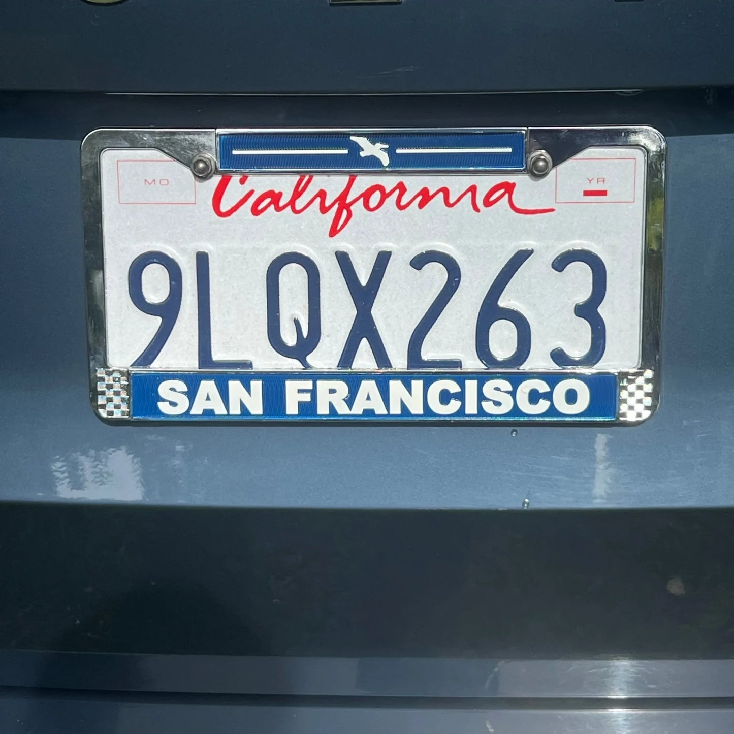 Lowkey Local San Francisco license plate frame in navy blue die cast metal with white lettering and pelican icon