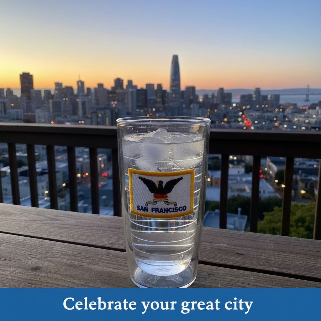 Lowkey Local San Francisco city flag Tervis tumbler on a wooden balcony overlooking the city skyline at sunset