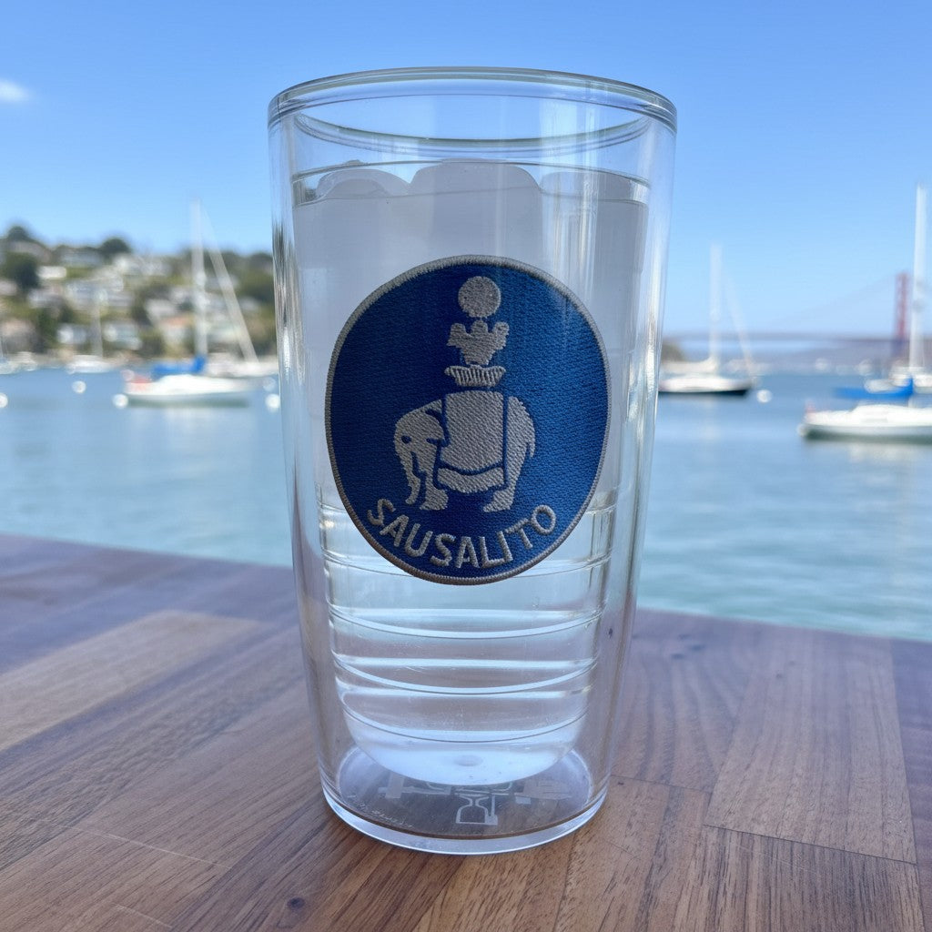 Lowkey Local 16oz Tervis tumbler featuring a blue Sausalito elephant patch, set against a scenic harbor background.