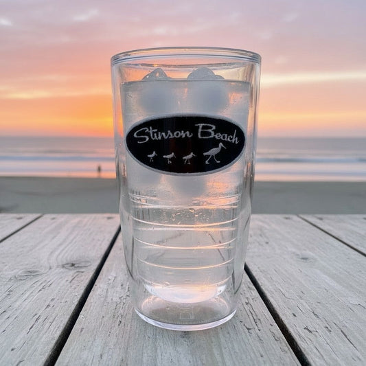 Lowkey Local 16oz Tervis tumbler featuring a Stinson Beach shore bird logo, set against a sunset beach background.