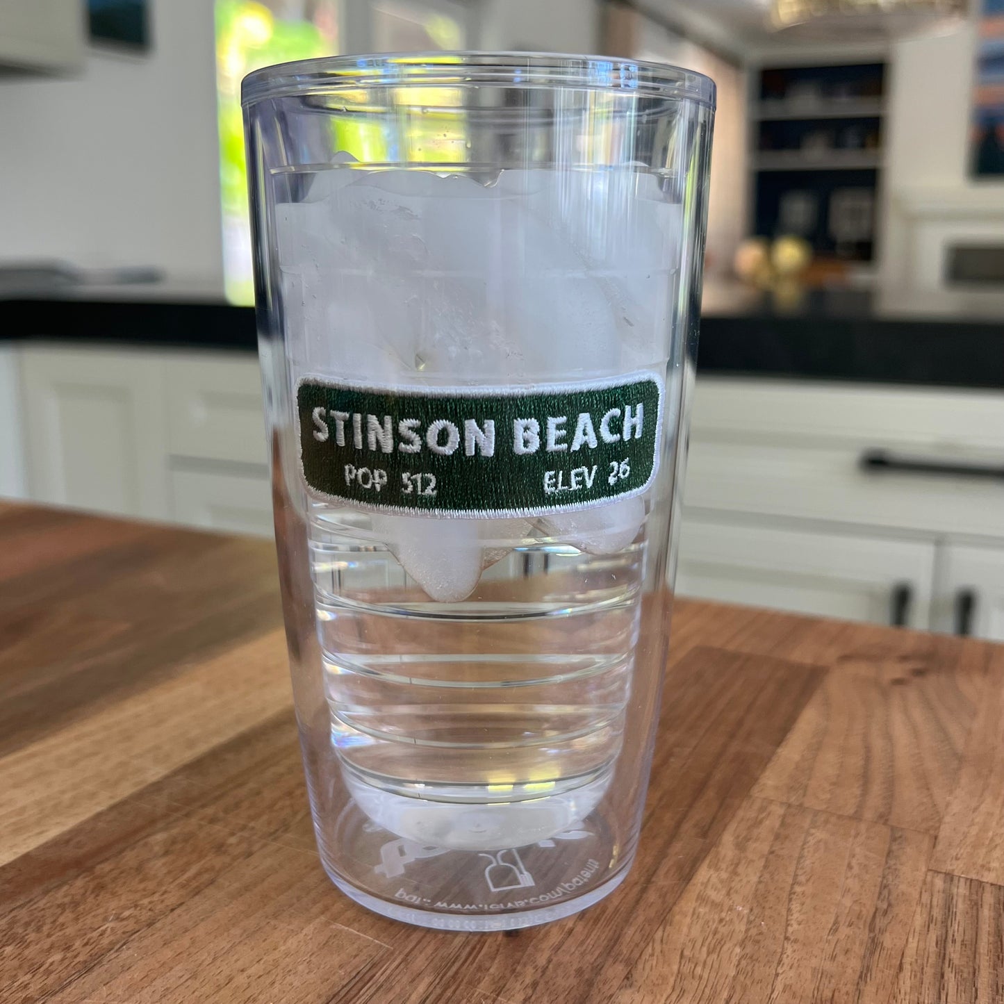 Lowkey Local Stinson Beach Tervis tumbler with double-wall insulation and green city limits patch filled with ice
