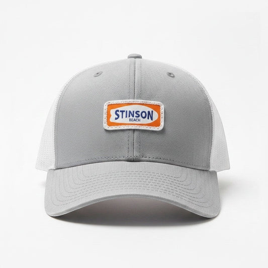 Lowkey Local Stinson Beach trucker hat with a grey front panel, white mesh back, and embroidered coastal patch.